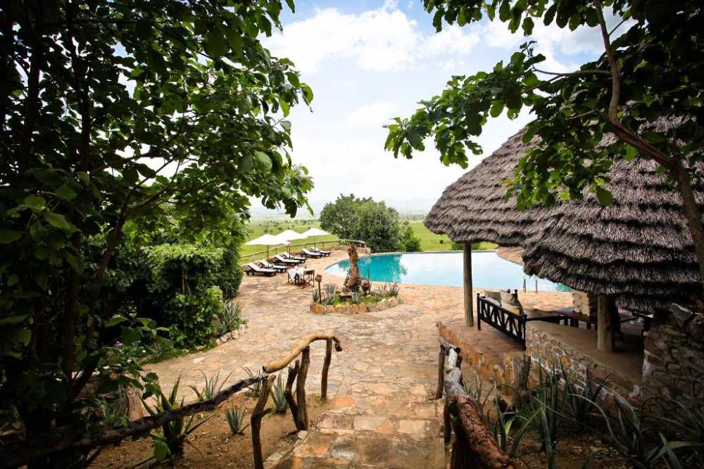 Luxury safari lodge and pool featured on the Pearl Odyssey Uganda Fly-In Safari