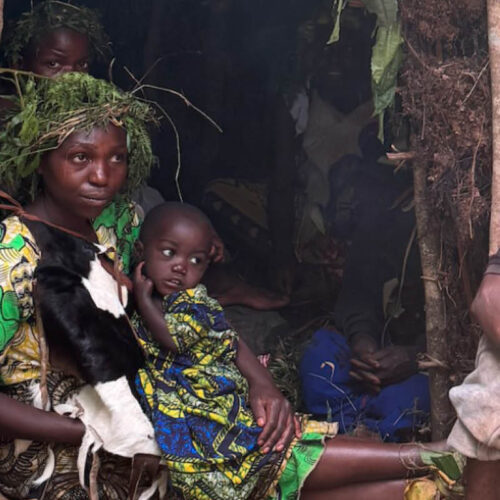 Batwa family demonstrating traditional forest life during a Batwa Experience near Bwindi Impenetrable National Park, Uganda