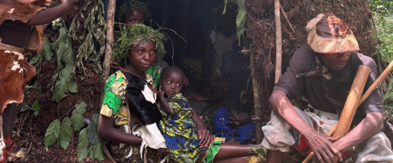Batwa family demonstrating traditional forest life during a Batwa Experience near Bwindi Impenetrable National Park, Uganda
