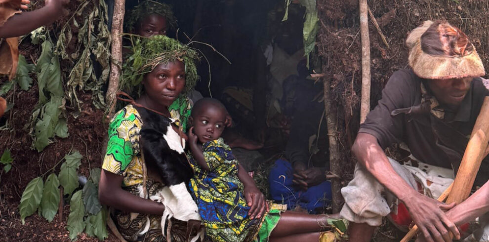Batwa family demonstrating traditional forest life during a Batwa Experience near Bwindi Impenetrable National Park, Uganda