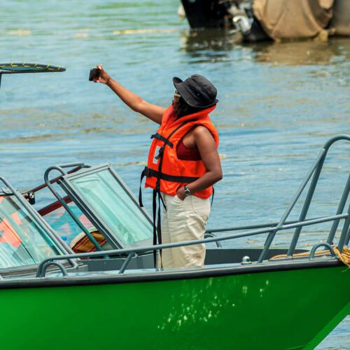 Visitors enjoying a wildlife boat safari on Uganda’s waterways while observing wildlife and scenic landscapes.
