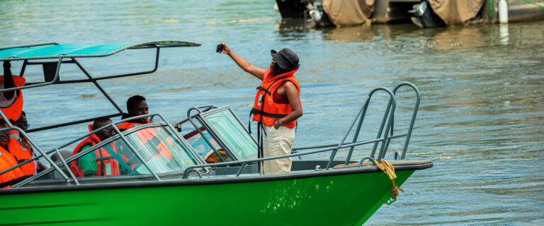 Visitors enjoying a wildlife boat safari on Uganda’s waterways while observing wildlife and scenic landscapes.