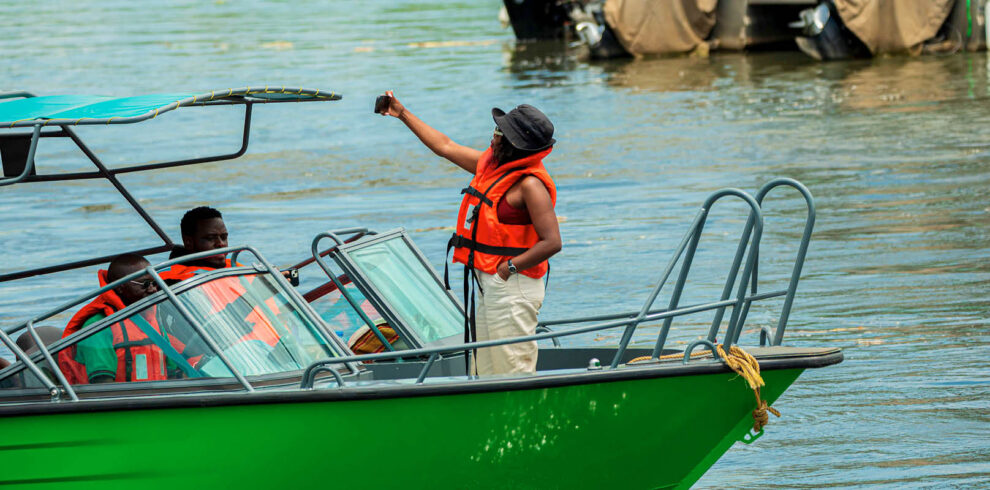 Visitors enjoying a wildlife boat safari on Uganda’s waterways while observing wildlife and scenic landscapes.