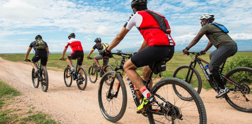 Travellers enjoying a guided cycling safari through Uganda’s scenic countryside