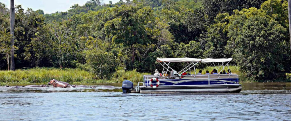 Family enjoying a guided boat safari in Uganda during a private family safari holiday