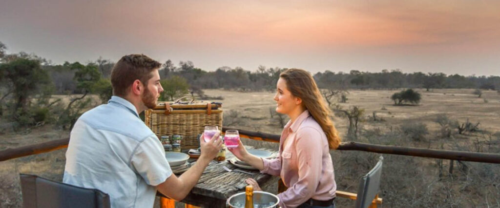 Couple enjoying a romantic safari sunset during a Honeymoon Safari in Uganda