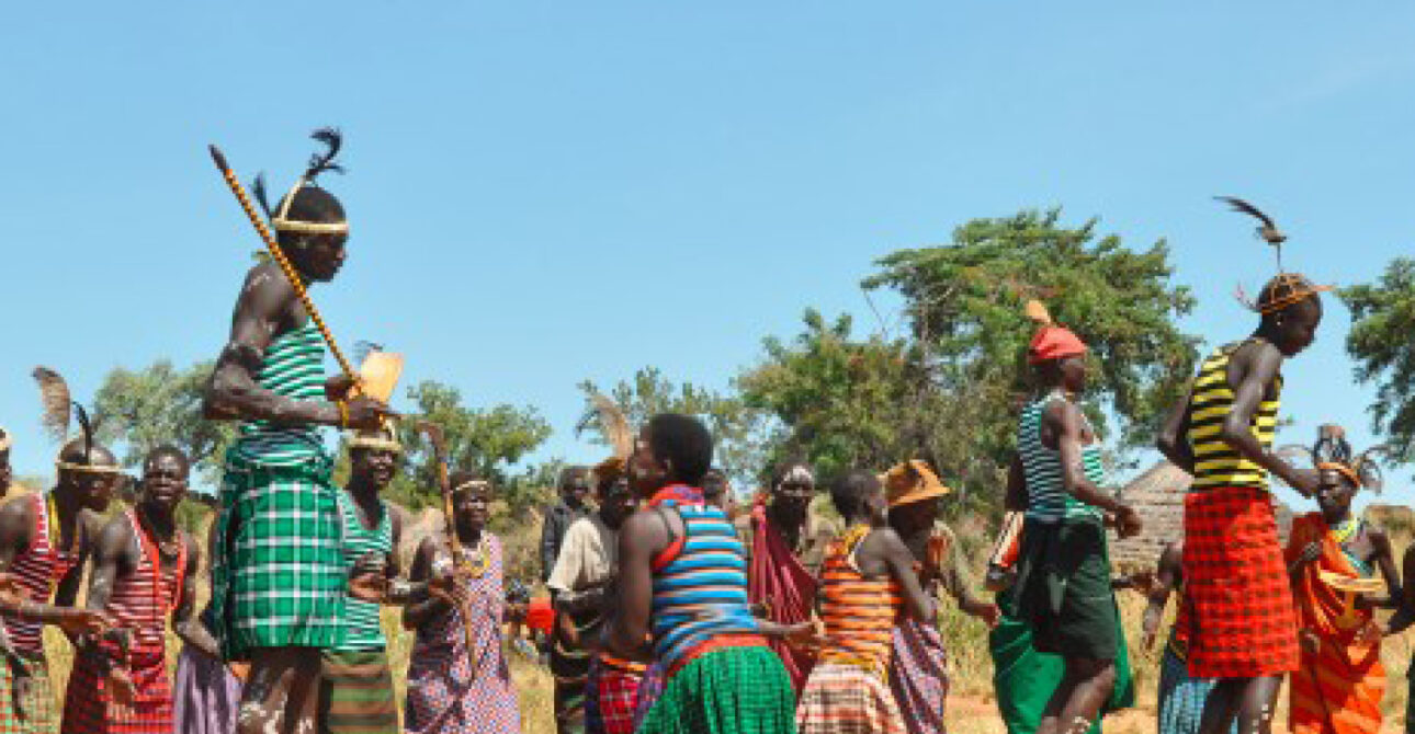 Traditional Karamojong cultural dancers performing during a community celebration in the Karamoja Region of Uganda.