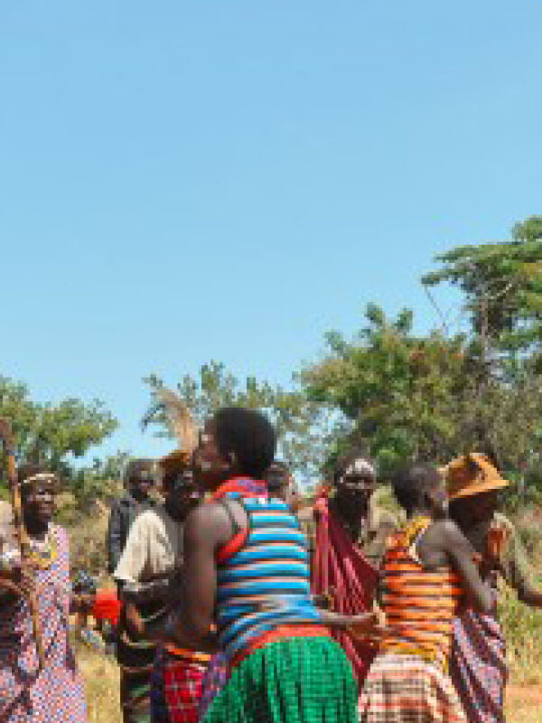 Traditional Karamojong cultural dancers performing during a community celebration in the Karamoja Region of Uganda.