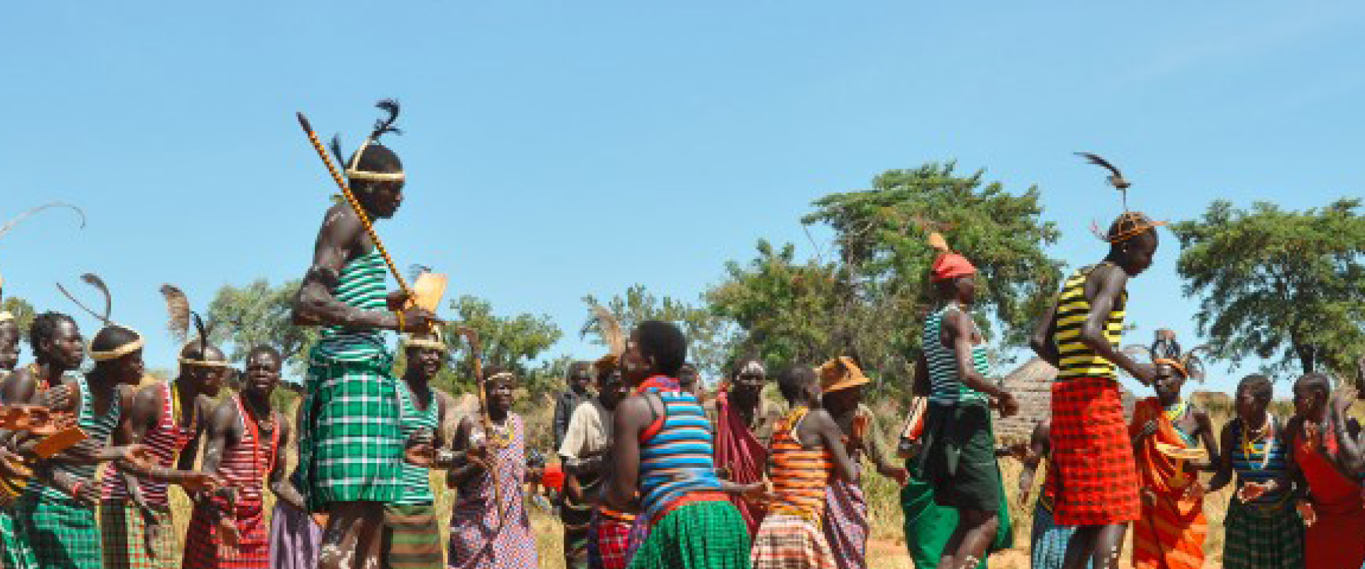 Traditional Karamojong cultural dancers performing during a community celebration in the Karamoja Region of Uganda.