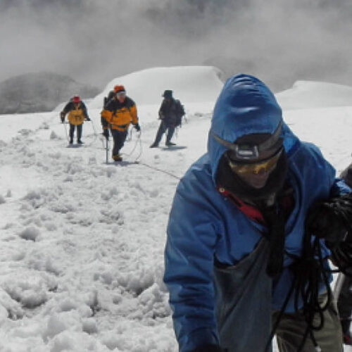 Climbers ascending the snow-covered slopes of Margherita Peak in Rwenzori Mountains National Park, Uganda’s legendary Mountains of the Moon.