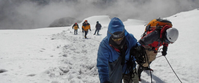 Climbers ascending the snow-covered slopes of Margherita Peak in Rwenzori Mountains National Park, Uganda’s legendary Mountains of the Moon.