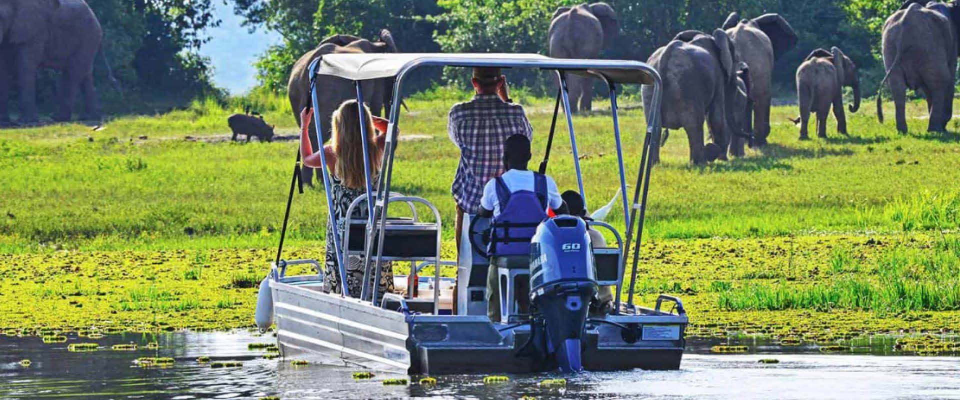 Guests enjoying a guided boat safari during a mid-range safaris in Murchison Falls National Park, Uganda