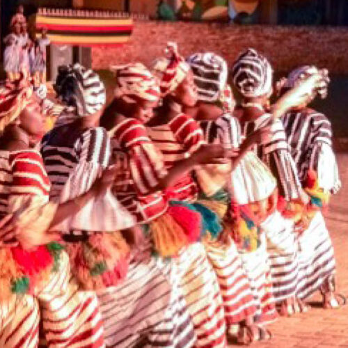 Traditional cultural dancers performing an authentic heritage dance during a Cultural Safari in Uganda