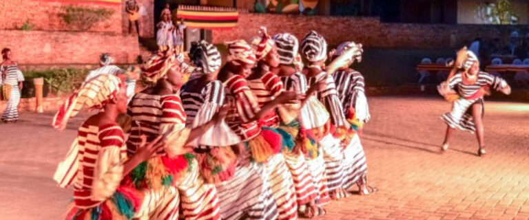 Traditional cultural dancers performing an authentic heritage dance during a Cultural Safari in Uganda