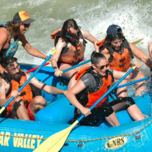 Travellers navigating exciting white water rapids during a rafting adventure on the River Nile in Jinja, Uganda