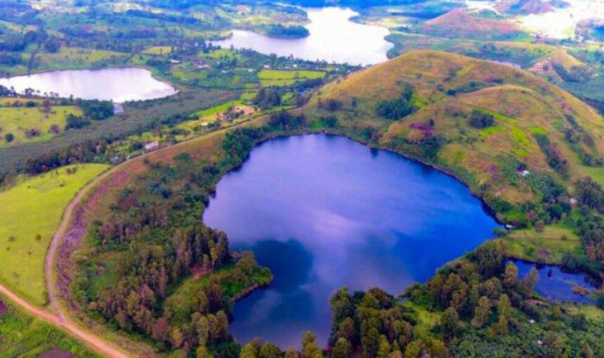Volcanic crater lake surrounded by lush hills near Fort Portal in western Uganda.