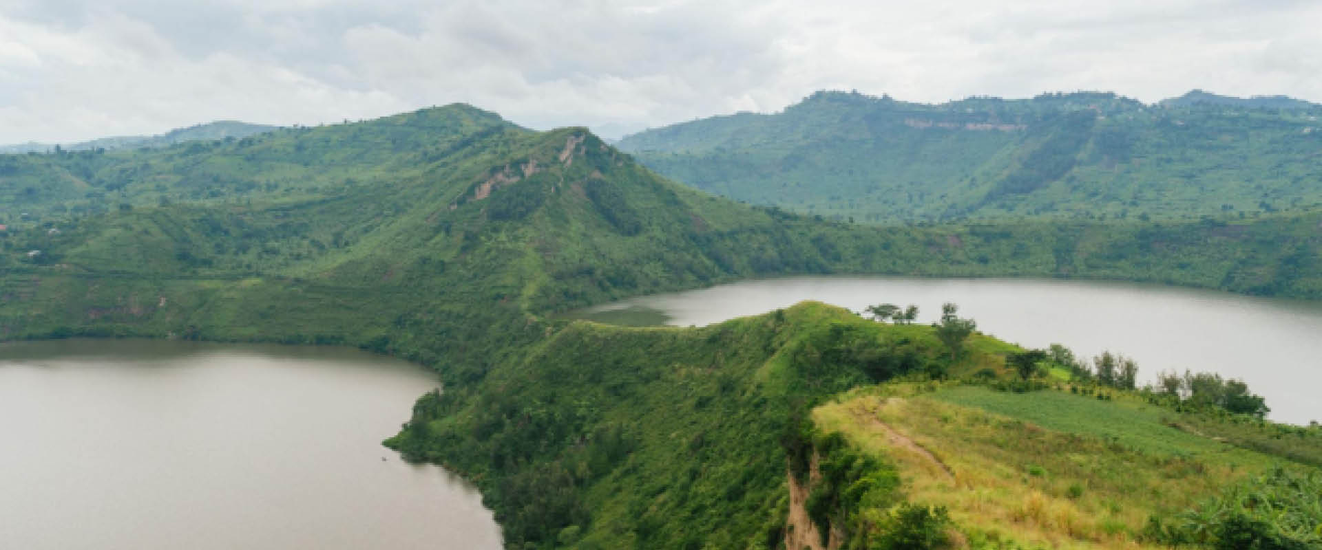 Panoramic view of Queen Elizabeth National Park with the Rwenzori Mountains showcasing Uganda’s diverse landscapes.