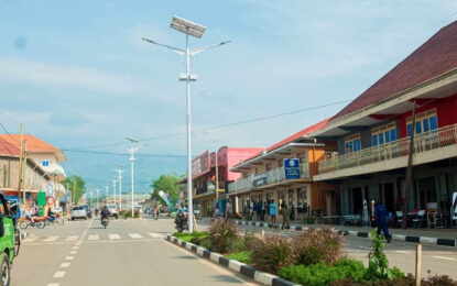 Busy African city street with shops, traffic and pedestrians