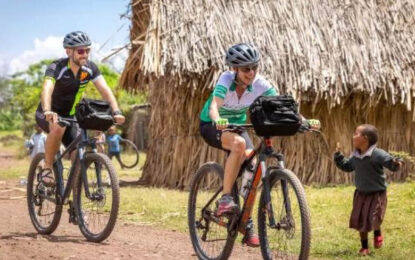 Cyclists riding through the rural countryside during an adventure safari in Uganda
