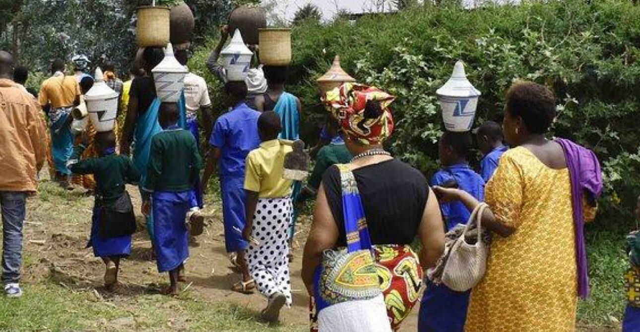 Nature Experiences in Uganda and Rwanda with travellers and community members walking along a rural trail