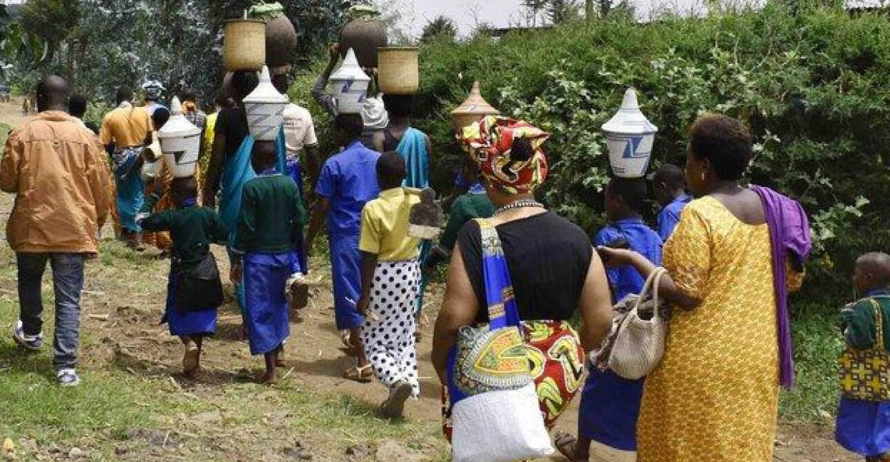 Village Walk in Uganda and Rwanda with community members walking along a rural path