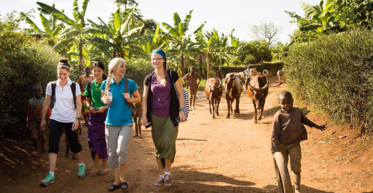 Village Walk in Uganda and Rwanda with travellers exploring a rural community