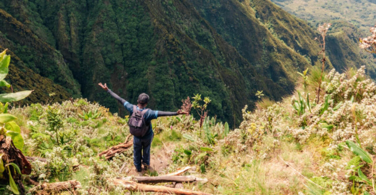 Hiker exploring a volcanic mountain trail in the Virunga region