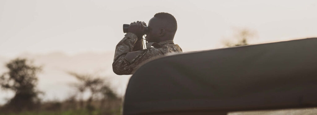 Bird watching in Uganda and Rwanda featuring a guide.