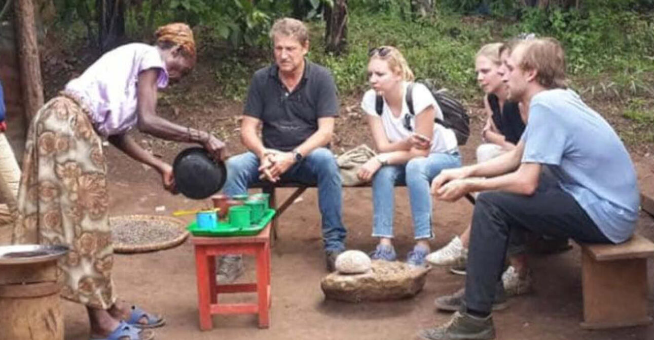 Cultural safari in Uganda with visitors learning from a local community