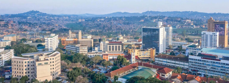 Panoramic view of Kampala, Uganda, showing the city’s buildings, green hills and surrounding urban landscape.