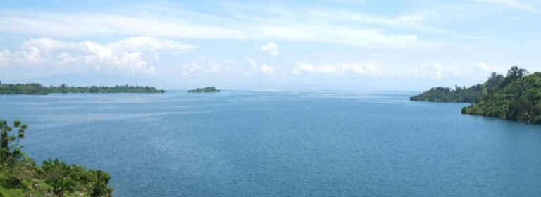 Panoramic view of Lake Kivu in Rwanda, showing the lake and surrounding hills near Karongi.