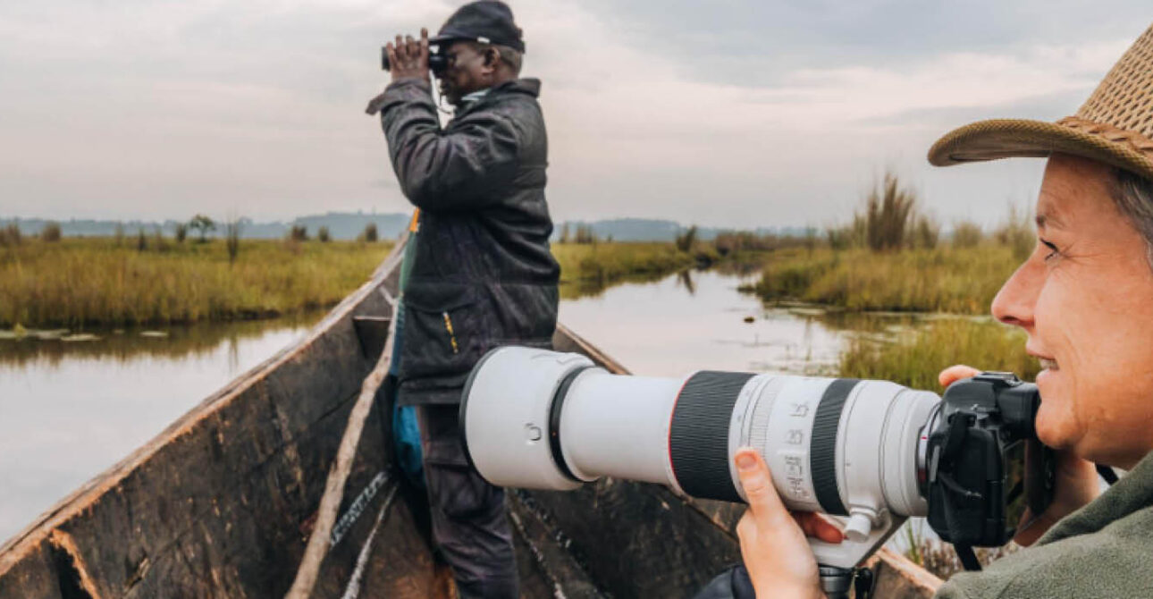 Photographer capturing wildlife during a Uganda photography tour